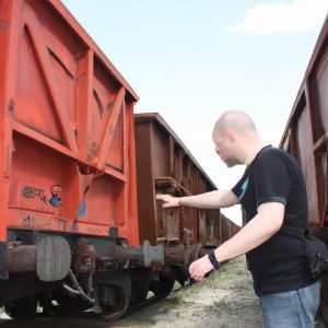 Person examining different rail cars